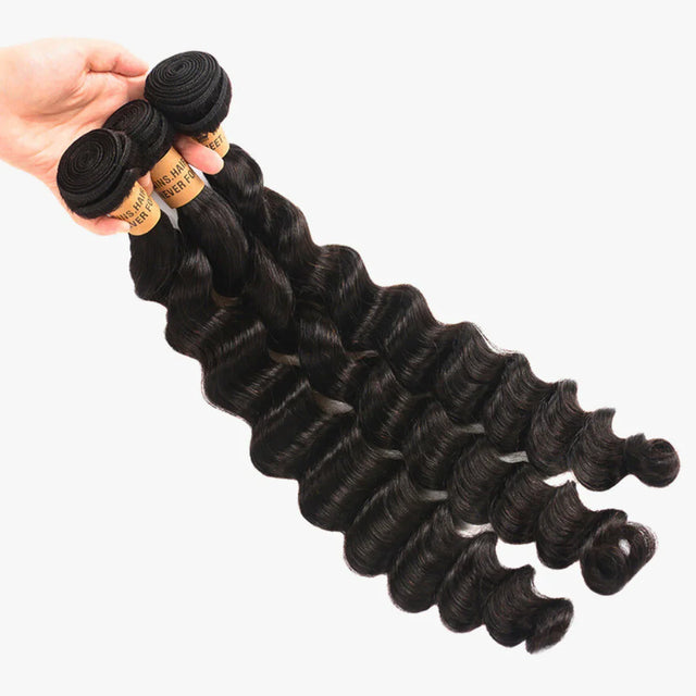 Deep wave human hair bundles with natural black color, held in hand for styling
