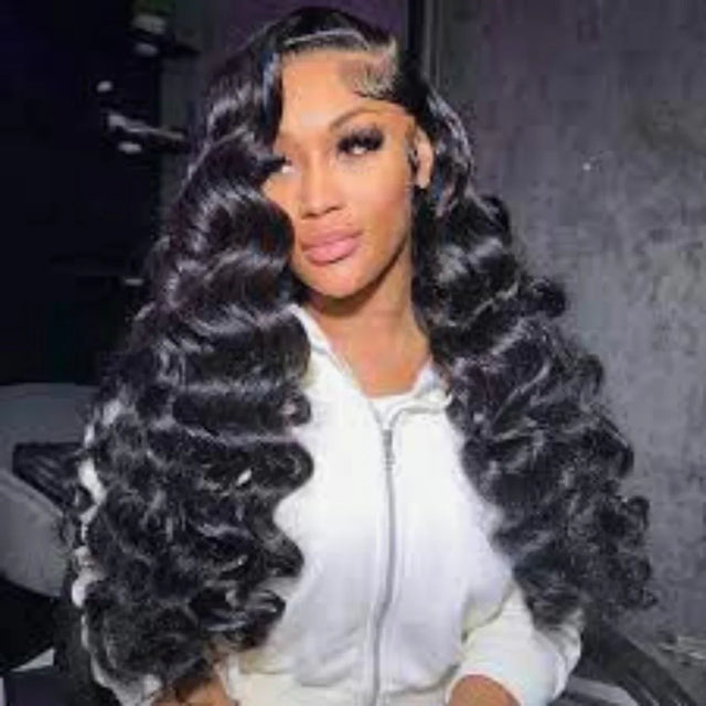 Woman wearing a deep wave human hair wig with lace front, styled in voluminous curls for natural look