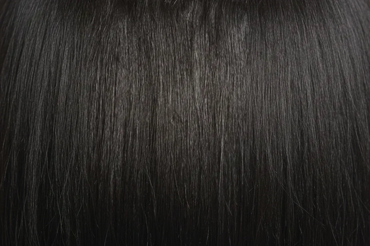 Two packages of Outre Premium Purple Pack Yaki hair extensions, showcasing the product as 100% human hair with a straight texture.