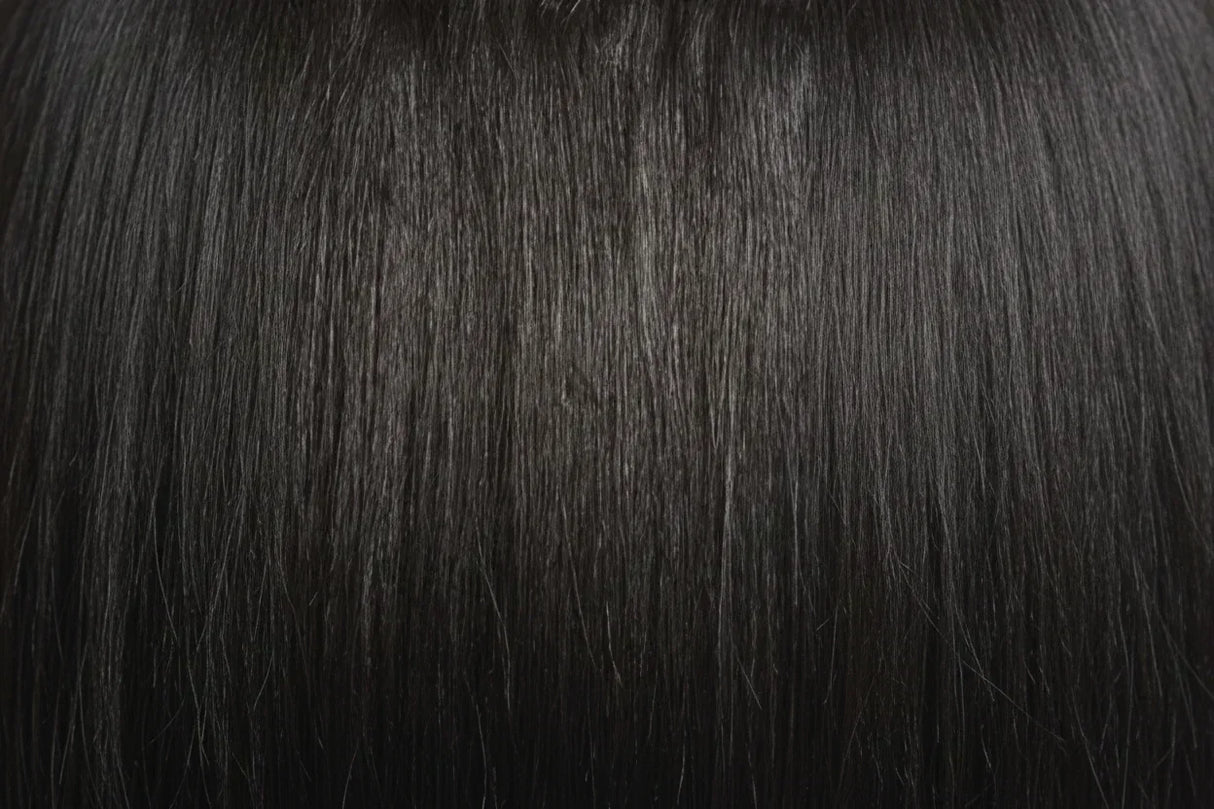 Two packages of Outre Premium Purple Pack Yaki hair extensions, showcasing the product as 100% human hair with a straight texture.
