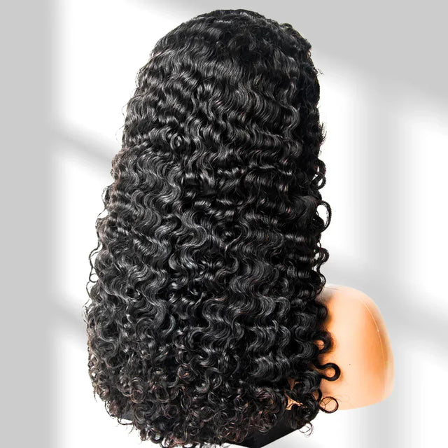Black curly wig on a mannequin head against a gray background