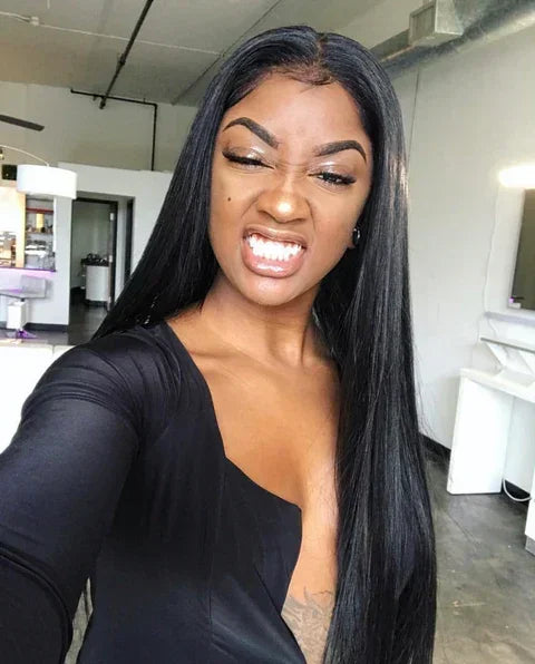 Woman with long sleek black human hair wig, natural styling in salon setting