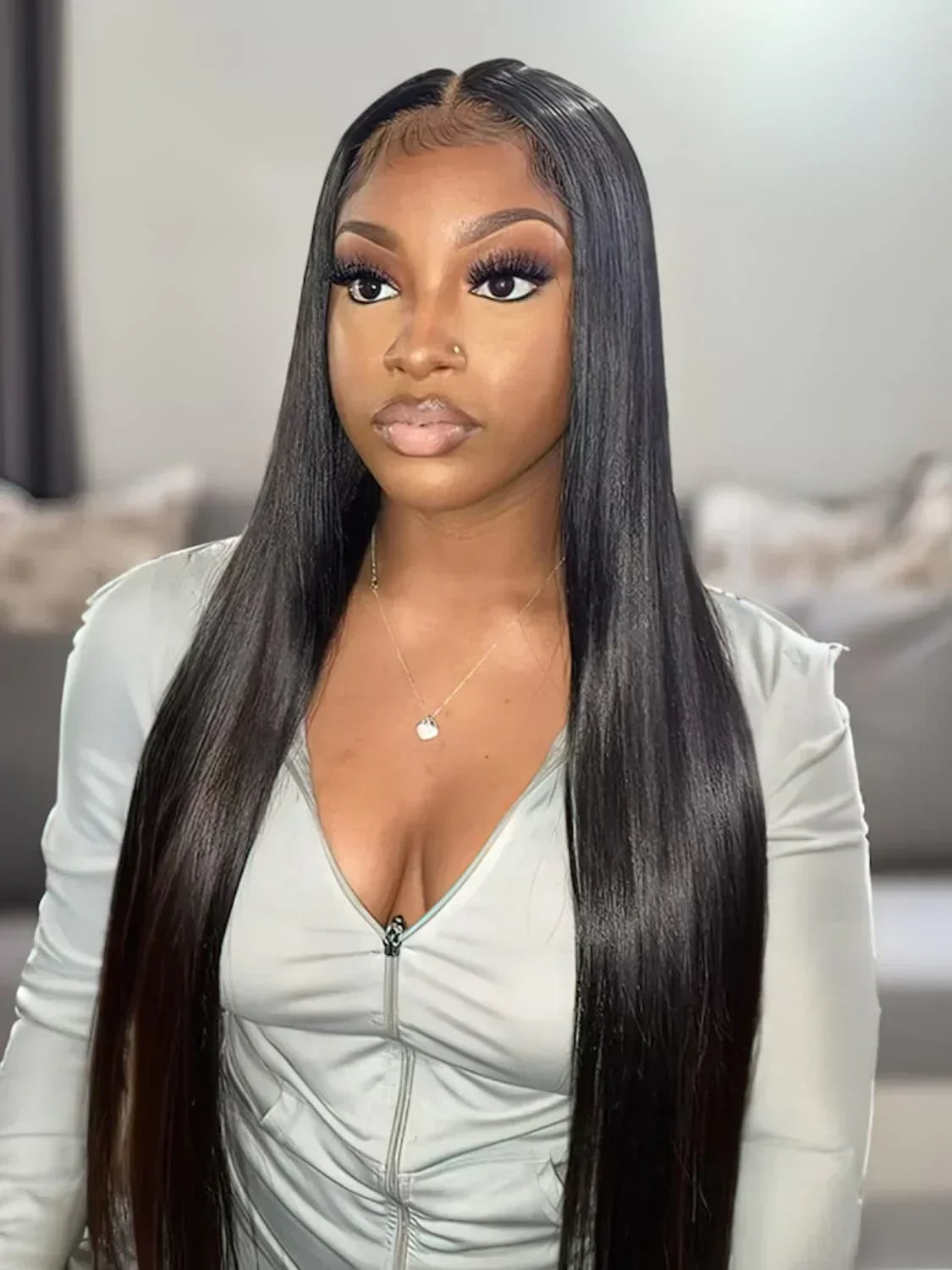 Woman wearing sleek black human hair wig with natural lace front, styled straight for everyday elegance.