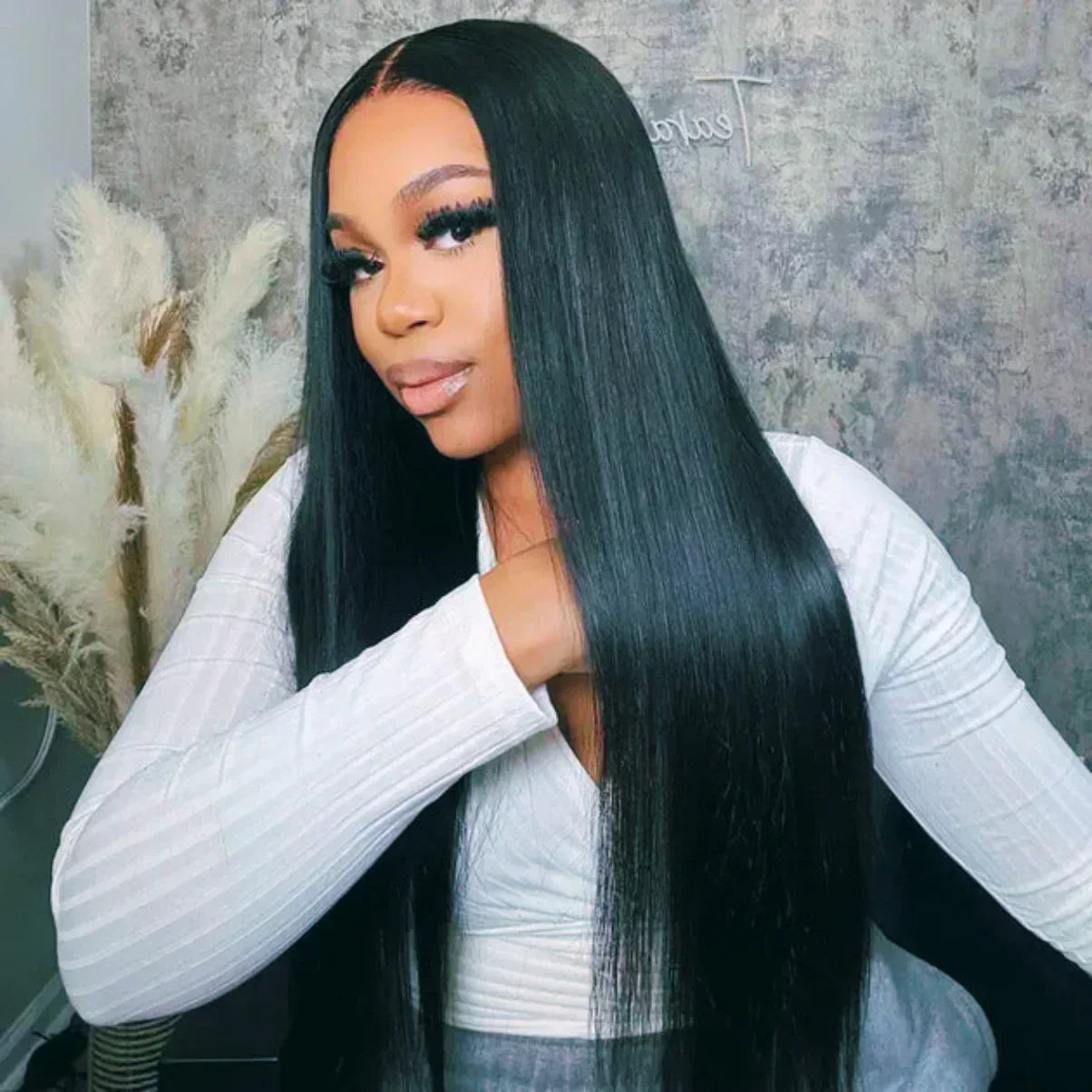Long straight human hair wig with natural part, sleek black texture for everyday styling