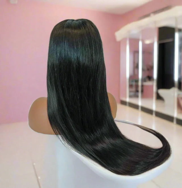 Long straight human hair wig on mannequin, sleek black style for natural look