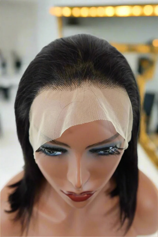 Natural-looking human hair wig with lace front on mannequin, styled sleek for realistic wear