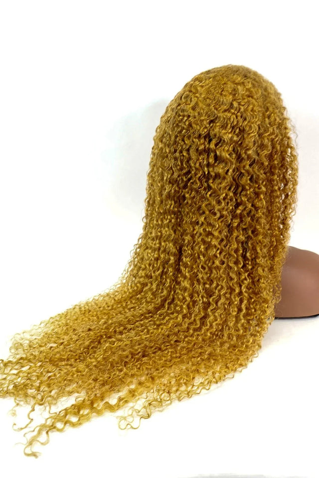 Golden curly human hair wig with voluminous waves, perfect for natural styling and versatile looks.