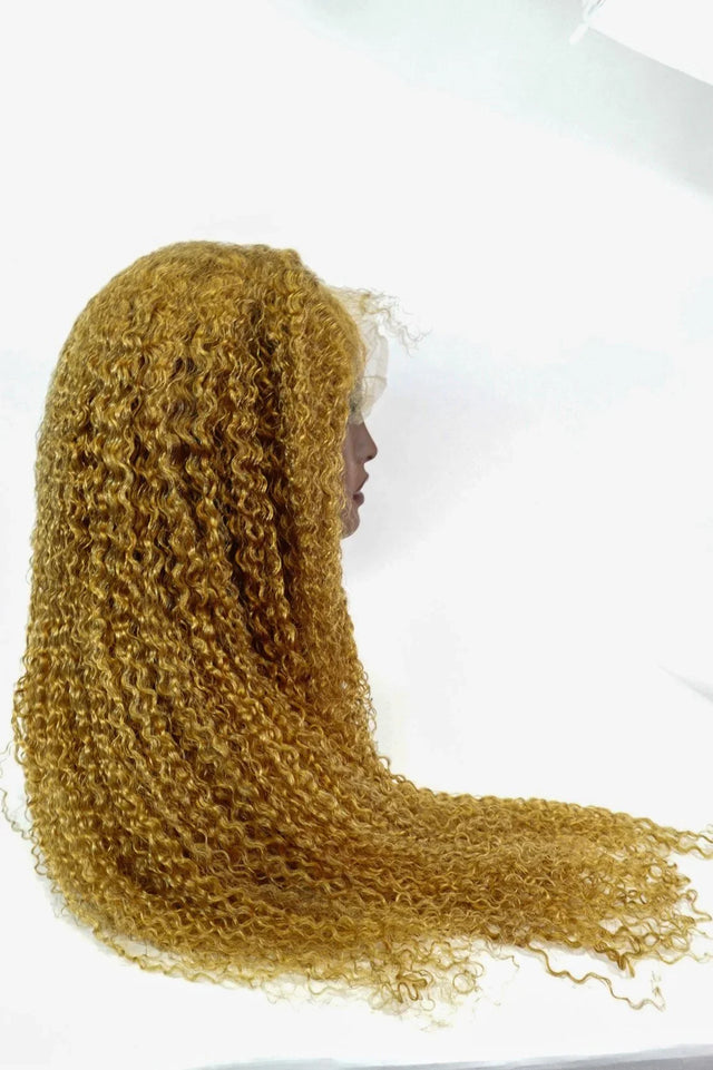 Golden curly human hair wig with lace front, natural voluminous curls for stylish everyday wear