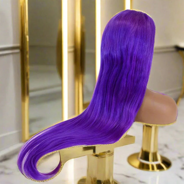 Vibrant purple human hair wig with sleek waves, displayed on mannequin in luxury salon setting