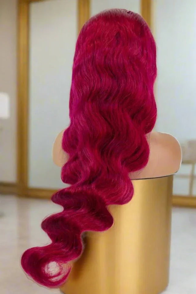 Vibrant red human hair wig with body waves displayed on mannequin, premium quality for natural styling