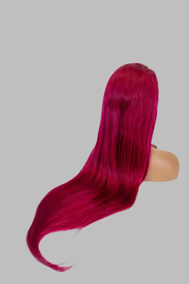 Vibrant fuchsia human hair wig with sleek, long straight style on mannequin head