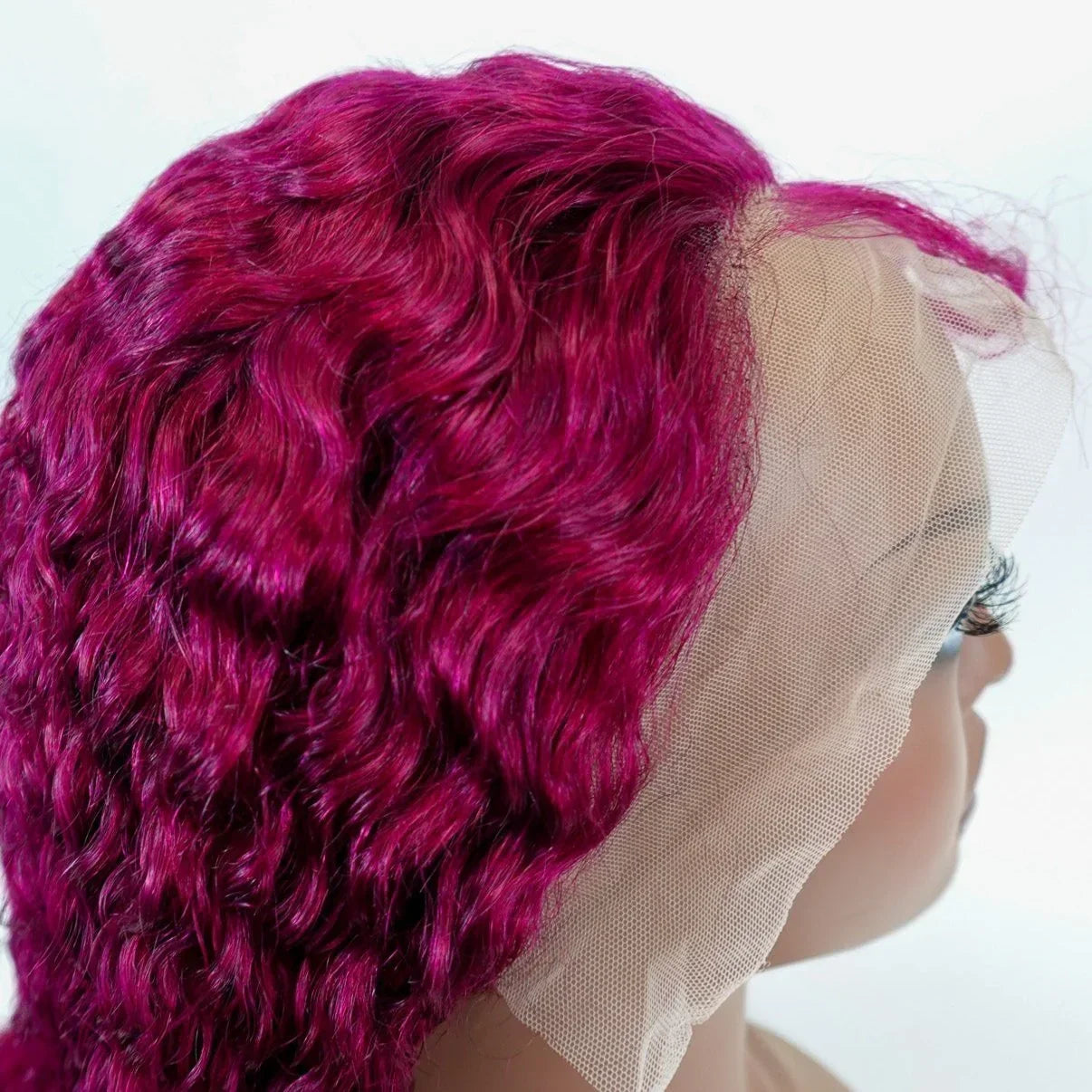 Vibrant magenta curly human hair wig with lace front for natural styling
