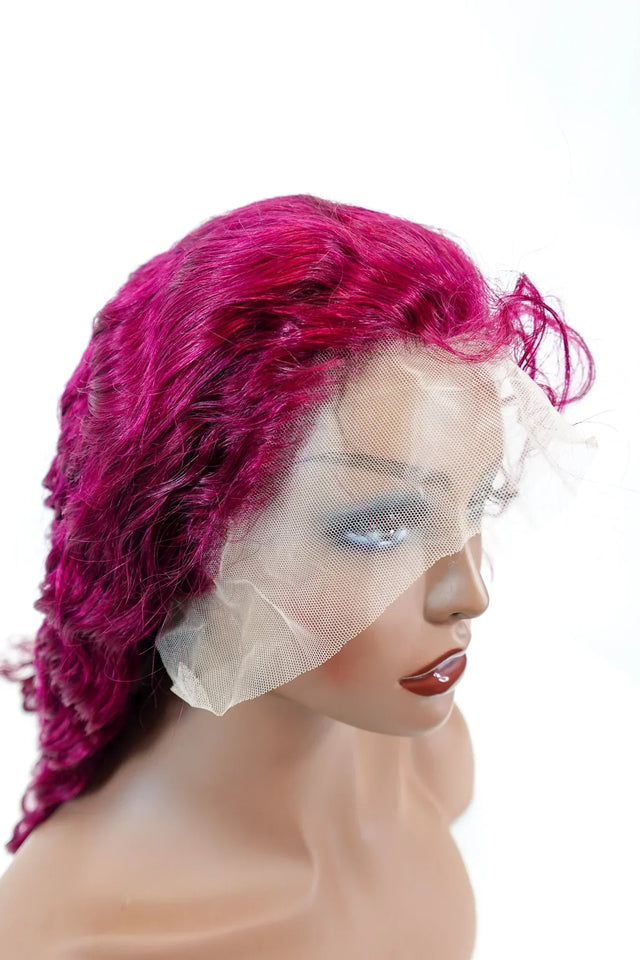 Vibrant magenta human hair lace front wig with natural curls on mannequin