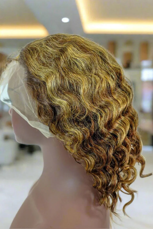 Curly human hair wig with lace front, natural waves and highlights on mannequin