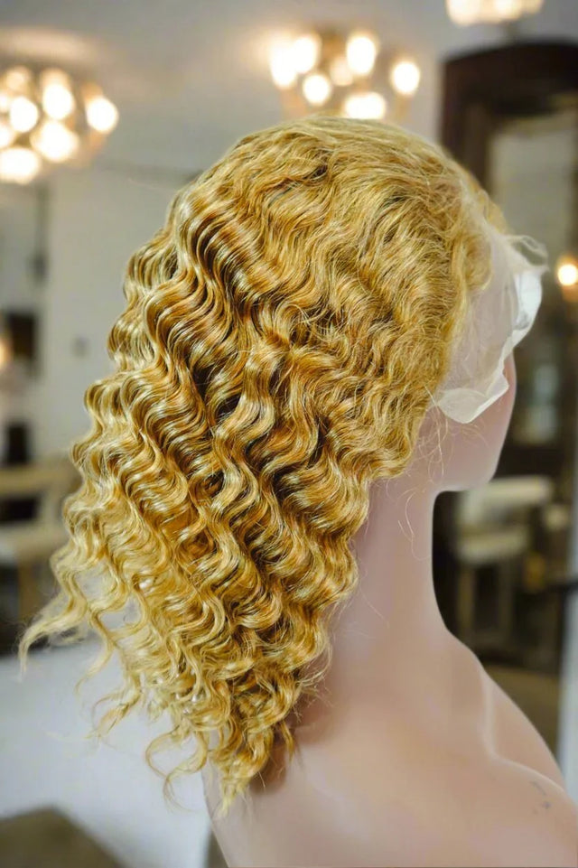 Blonde curly human hair wig on mannequin, natural voluminous waves for stylish look