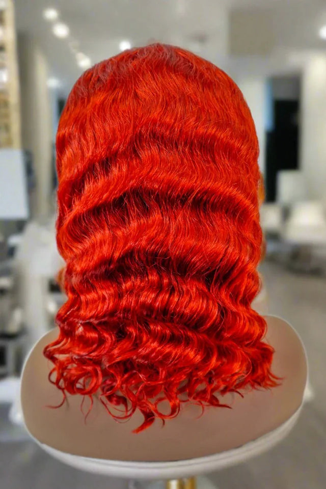 Vibrant red human hair wig with deep waves on mannequin, salon-style display