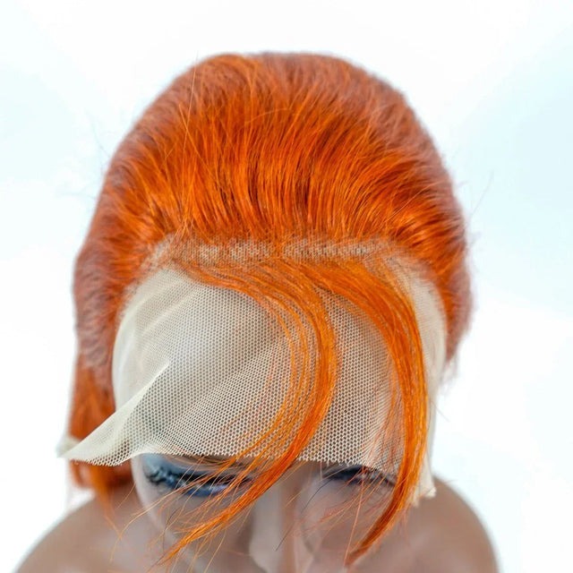 Vibrant orange human hair lace front wig with natural-looking scalp mesh, styled on mannequin head