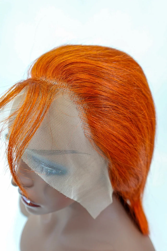 Vibrant orange human hair lace front wig on mannequin, showcasing natural-looking hairline and premium texture