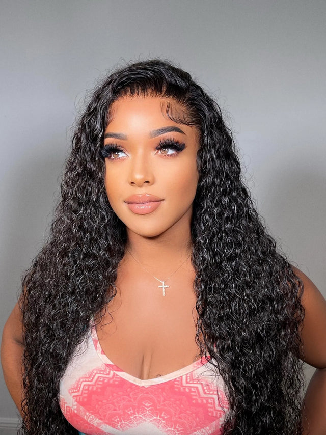 Long curly human hair wig with natural lace front, styled for volume and texture