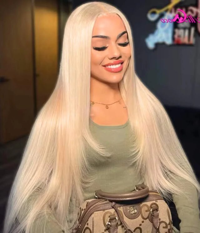 Woman wearing long platinum blonde human hair wig, styled straight for natural look