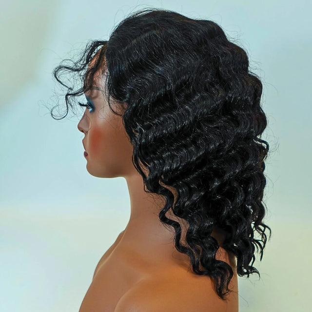 Black curly human hair wig on mannequin, natural voluminous waves for stylish look
