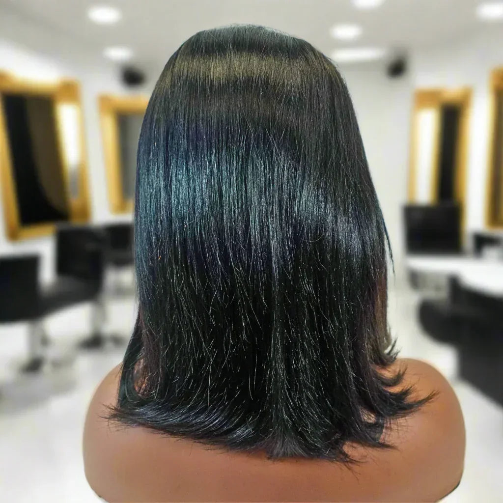 Smooth black human hair wig with subtle blue highlights, styled in a sleek shoulder-length cut.