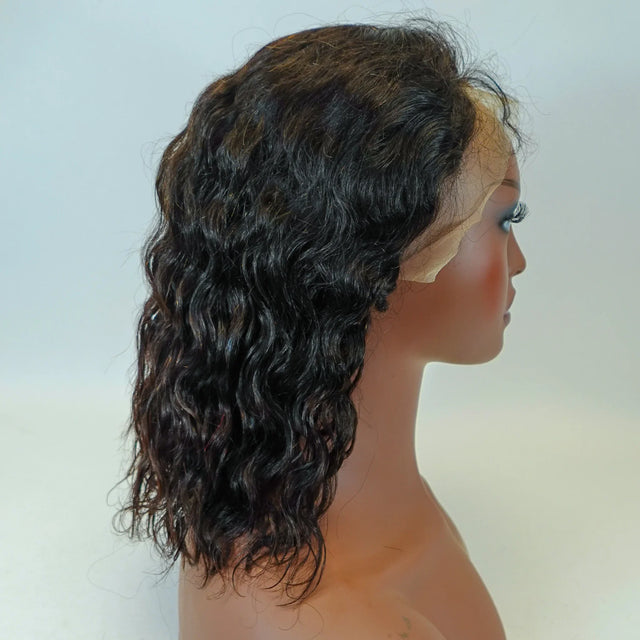 Natural curly human hair wig with lace front on mannequin, showcasing voluminous waves and seamless blend.