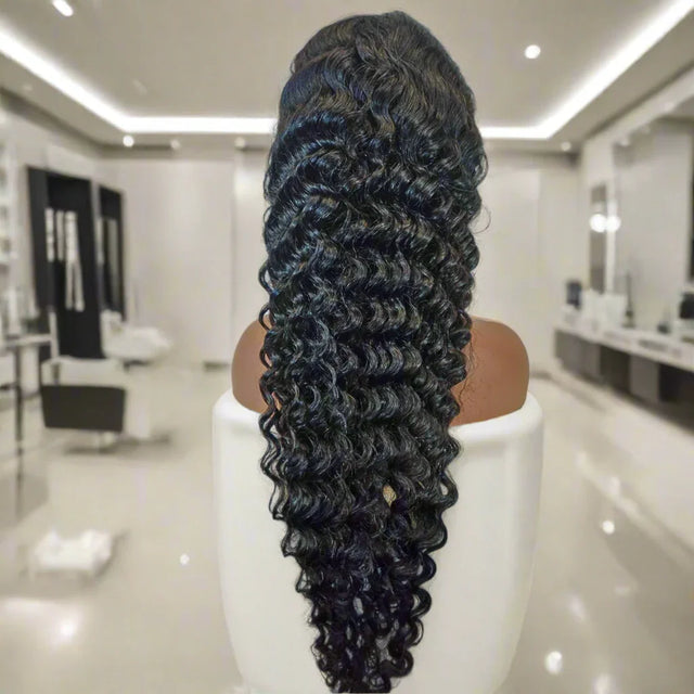 Luxury human hair wig with deep curls, displayed on mannequin in modern salon setting