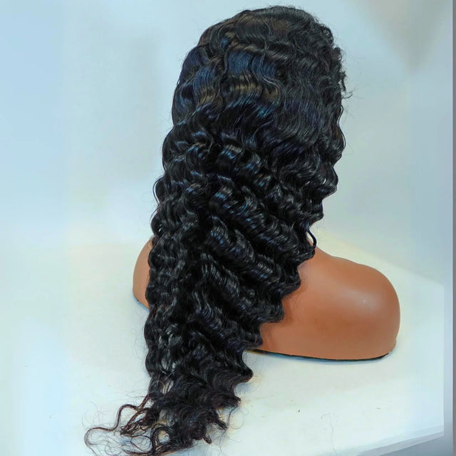 Deep curly human hair wig on mannequin, natural voluminous waves for stylish looks