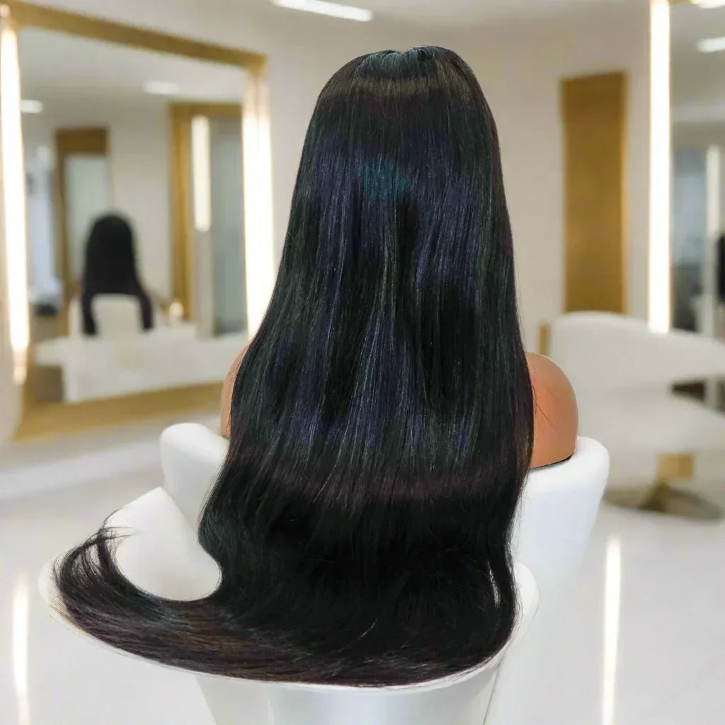 Long straight human hair wig with subtle blue highlights, displayed on mannequin in salon setting