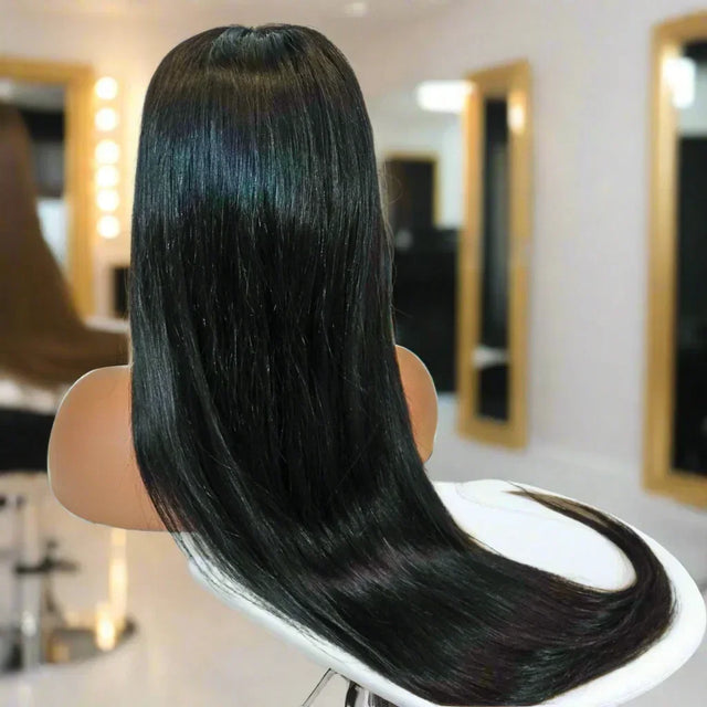 Long straight black human hair wig on mannequin in salon setting, sleek and shiny for natural styling