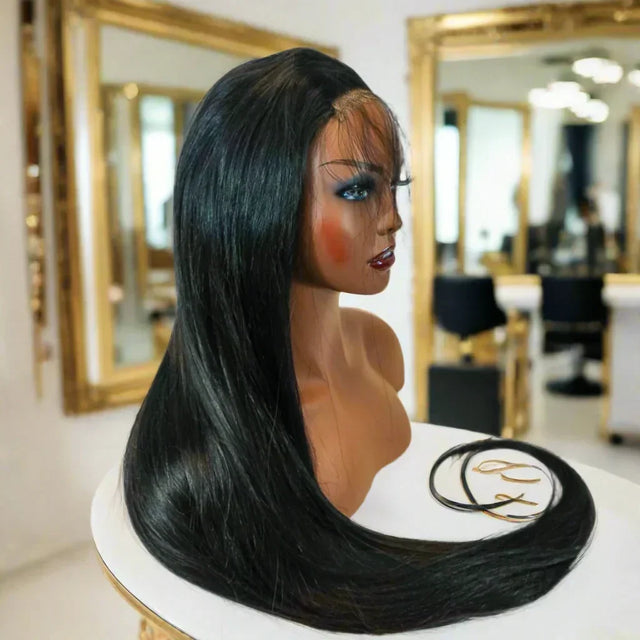 Long straight human hair wig on mannequin, salon setting with gold mirrors, natural styling