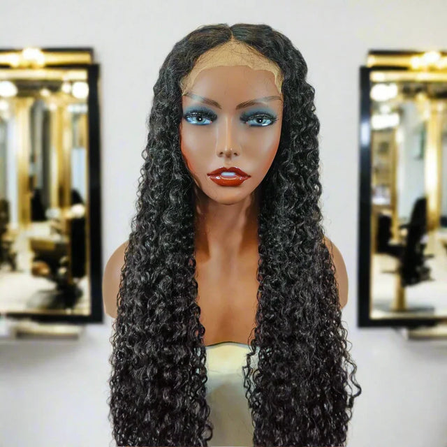 Long curly human hair wig with lace front on mannequin, salon mirror background
