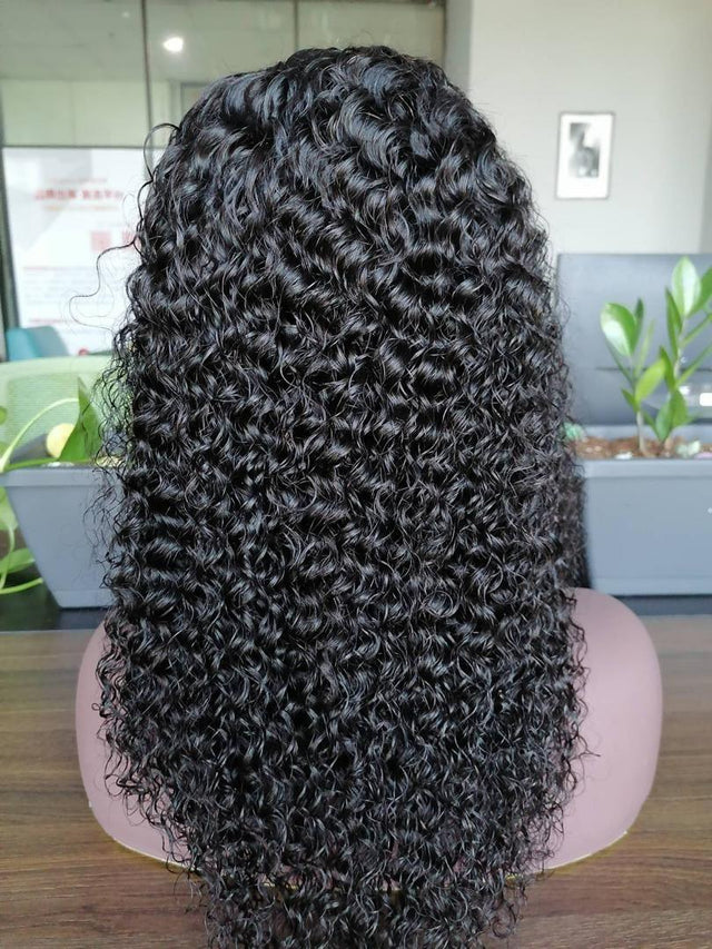 Black curly human hair wig on mannequin, natural voluminous texture for stylish looks