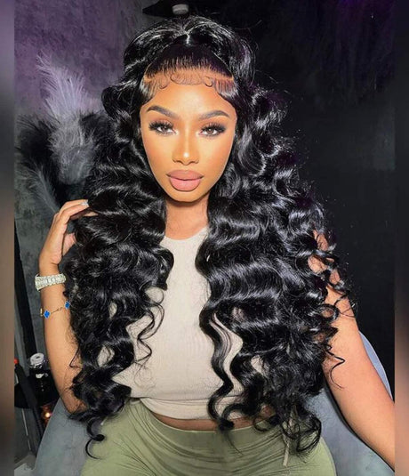 Woman wearing long, deep wave human hair wig with lace front and baby hairs, styled for natural look.