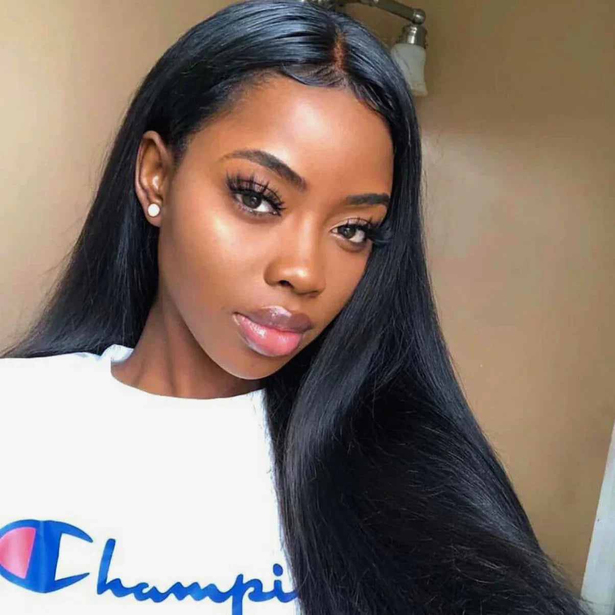 Woman wearing sleek black human hair wig with natural part, styled straight for everyday elegance