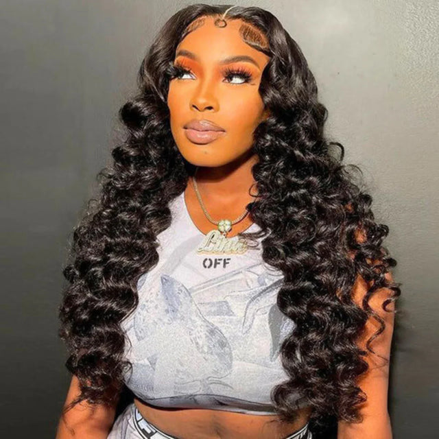 Woman wearing long, deep curly human hair wig with lace front, styled for natural volume and texture