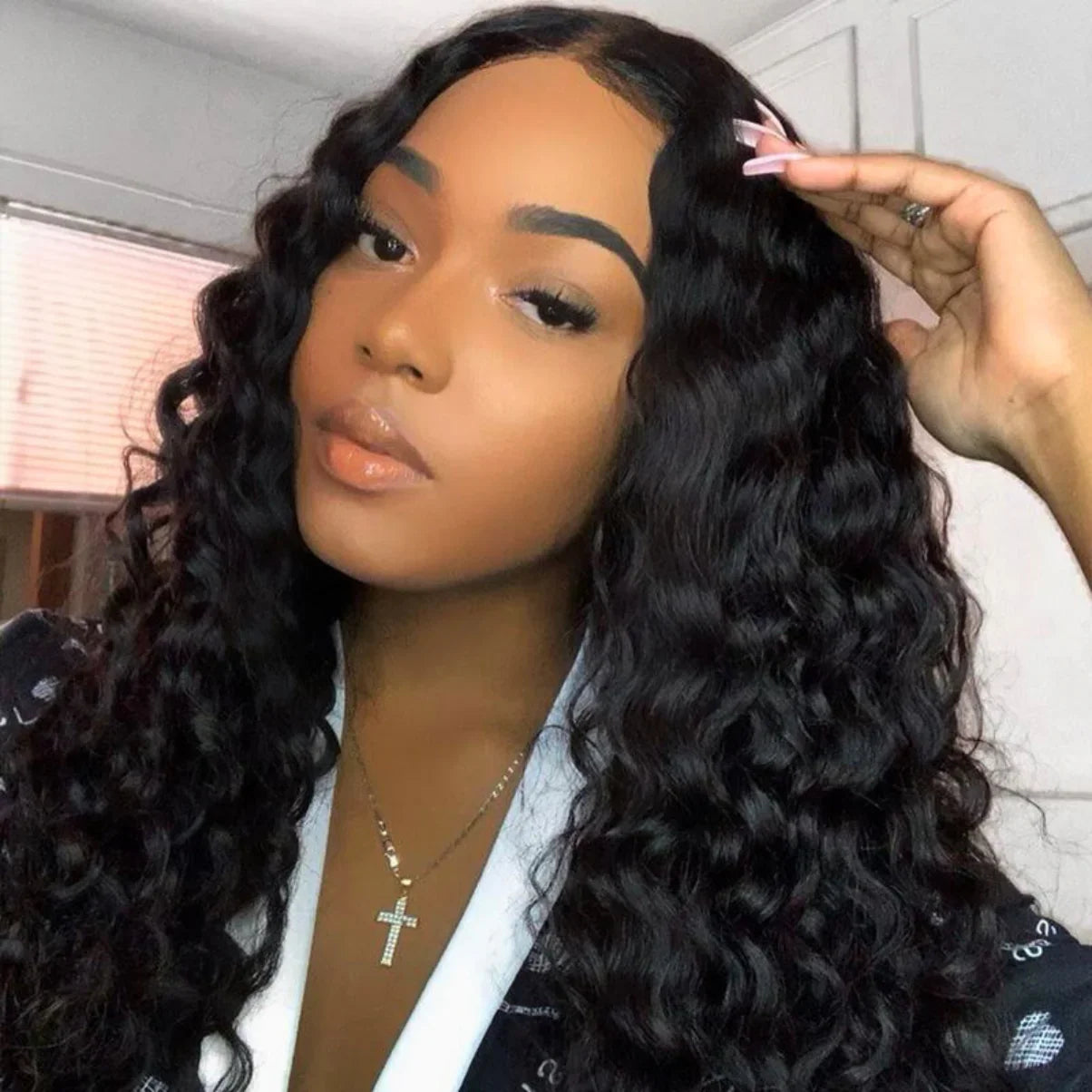 Woman wearing deep wave human hair wig with natural-looking lace front, styled with pink hair clip