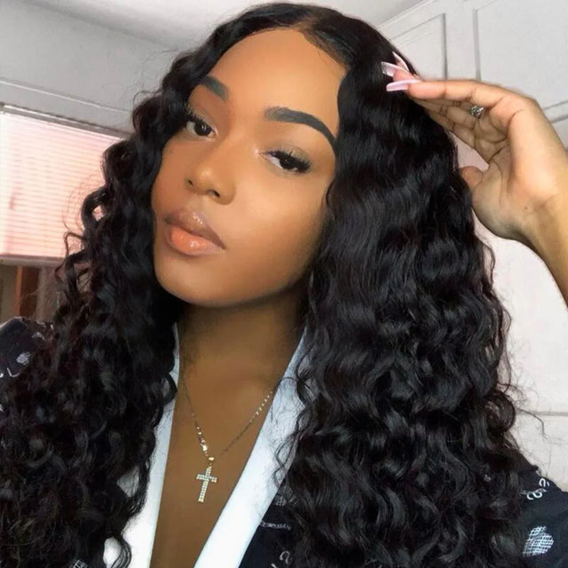 Woman wearing deep wave human hair wig with natural-looking lace front, styled with pink hair clip
