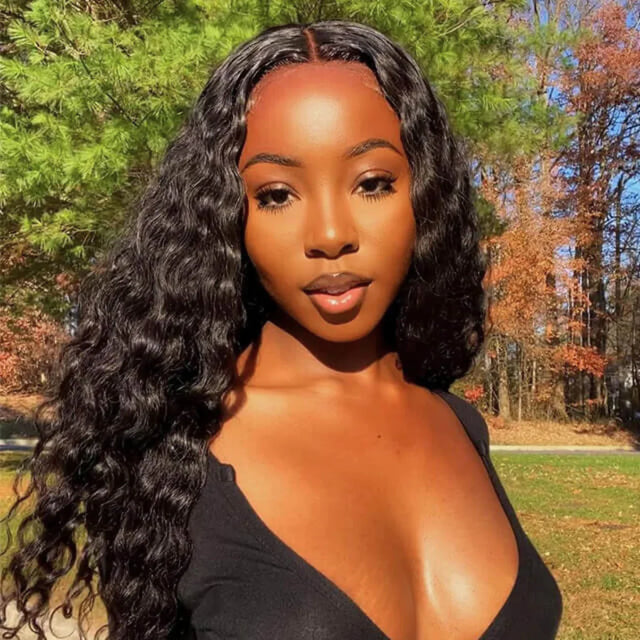 Woman wearing a deep wave human hair wig outdoors with natural styling