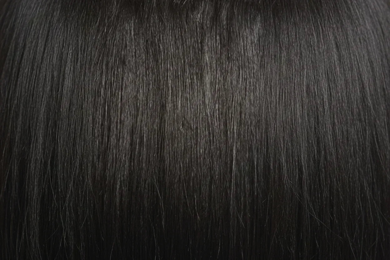 Two packages of Outre Premium Purple Pack Yaki hair extensions, showcasing the product as 100% human hair with a straight texture.