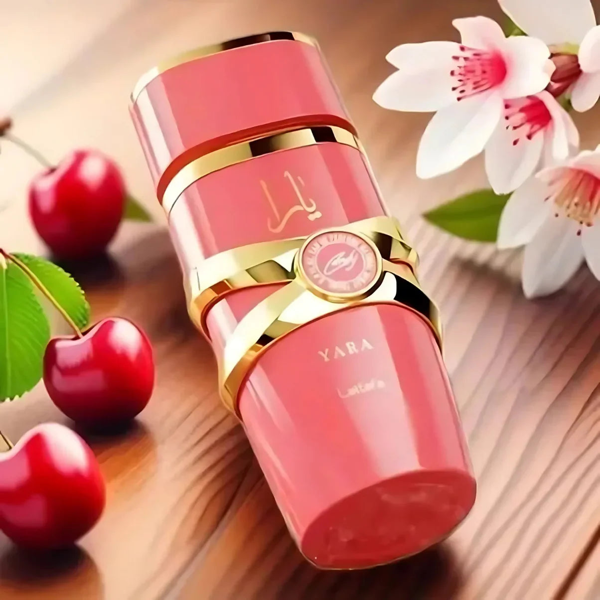Pink YARA beauty product with gold accents, cherries, and cherry blossoms on wood