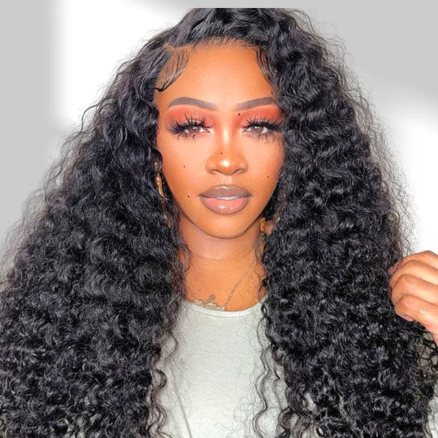Woman with long, curly black hair wearing a white top.