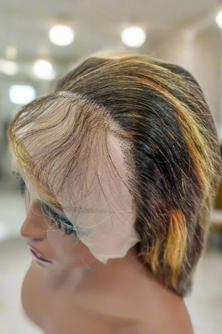 Human hair lace front wig with natural part and blended highlights on mannequin
