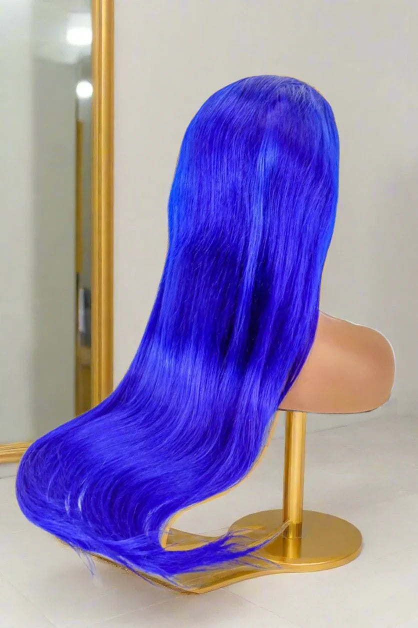 Vibrant blue human hair wig on mannequin, long straight style for bold natural looks