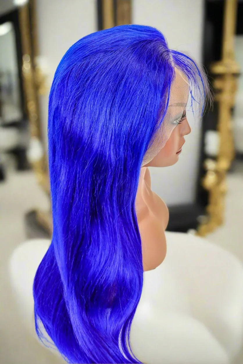 Vibrant blue human hair wig with lace front, long wavy style on mannequin head