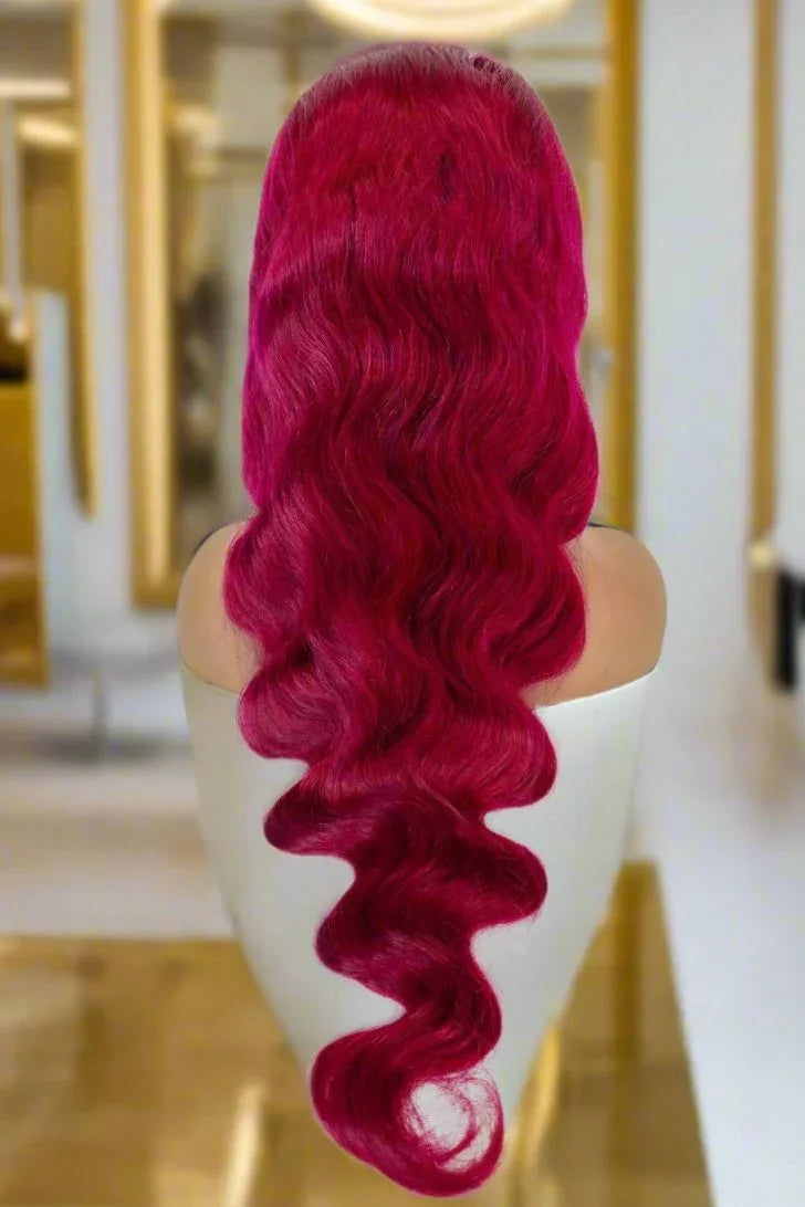 Vibrant red human hair wig with loose waves on mannequin, salon-style display