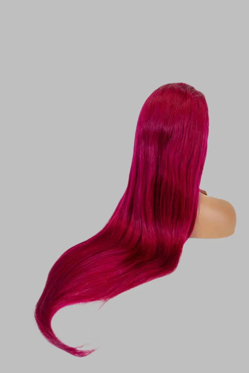 Vibrant fuchsia human hair wig with sleek, long straight style on mannequin head