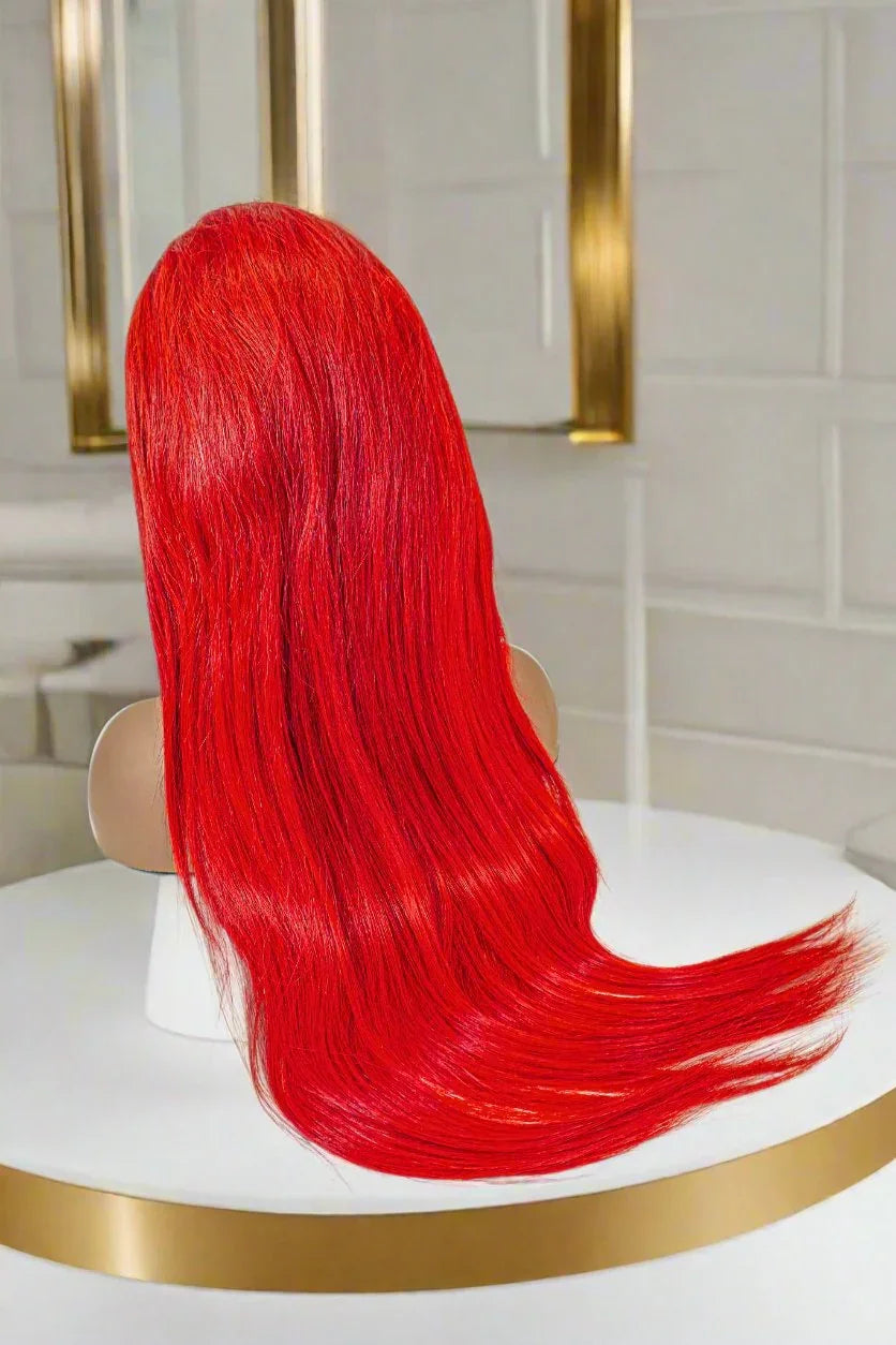 Vibrant red human hair wig on mannequin, sleek long style for natural look