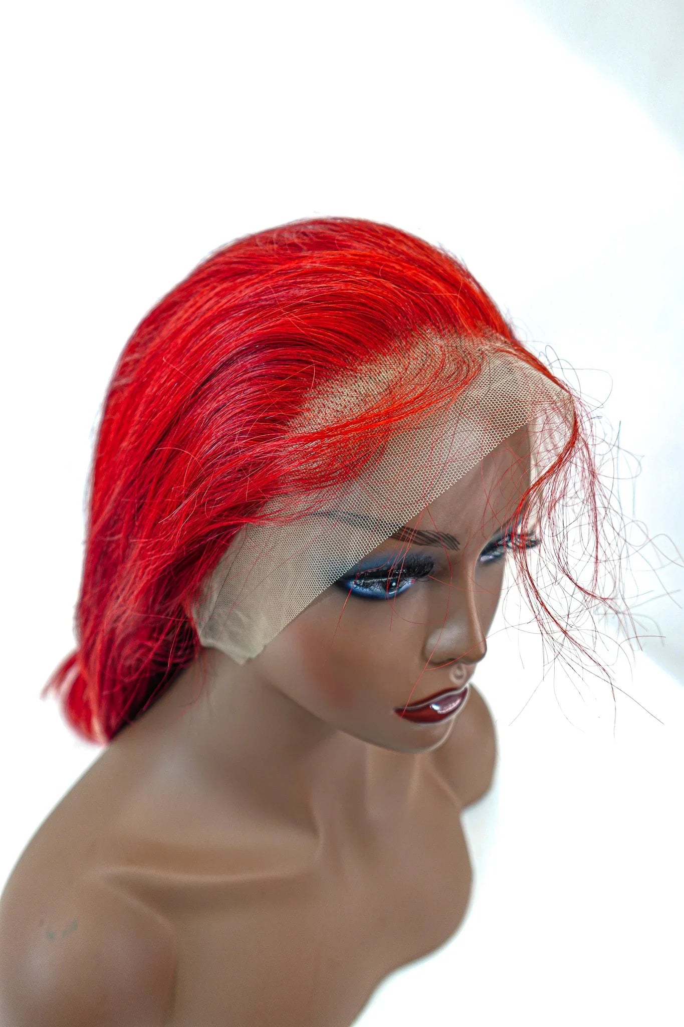 Vibrant red human hair lace front wig on mannequin, natural styling ready